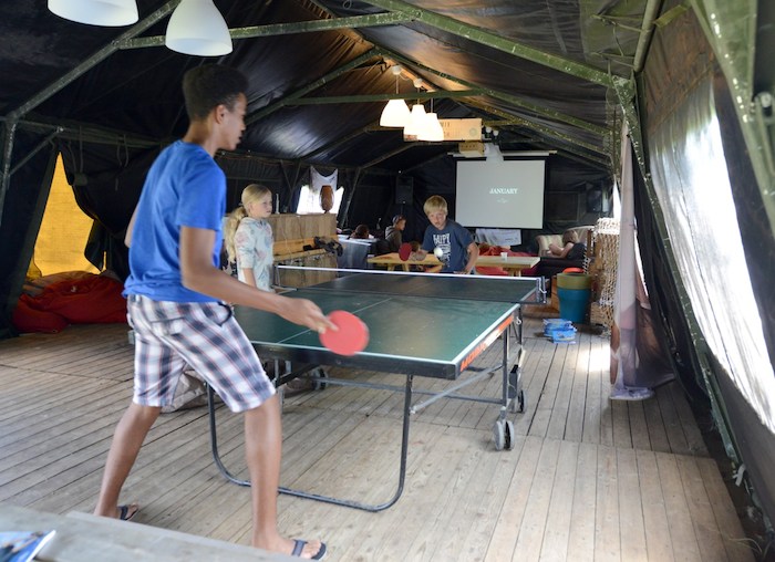 Jongens spelen een potje tafeltennis tussen het surfen door tijdens het surfkamp