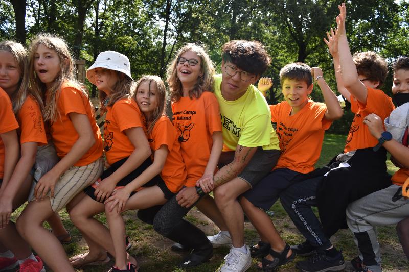 deelnemers met begeleiders spelen een buitenactiviteit tijdens een jongerenvakantie nederland