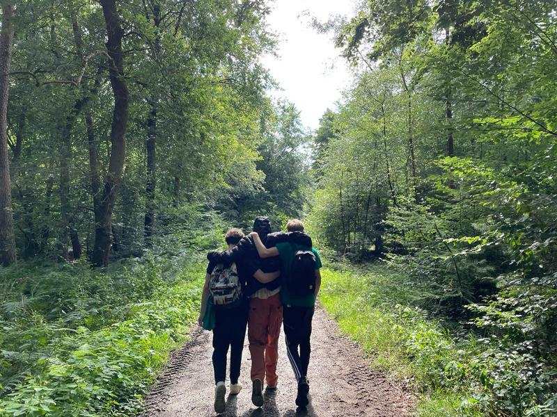 Deelnemers maken een boswandeling tijdens een zomerkamp Achterhoek