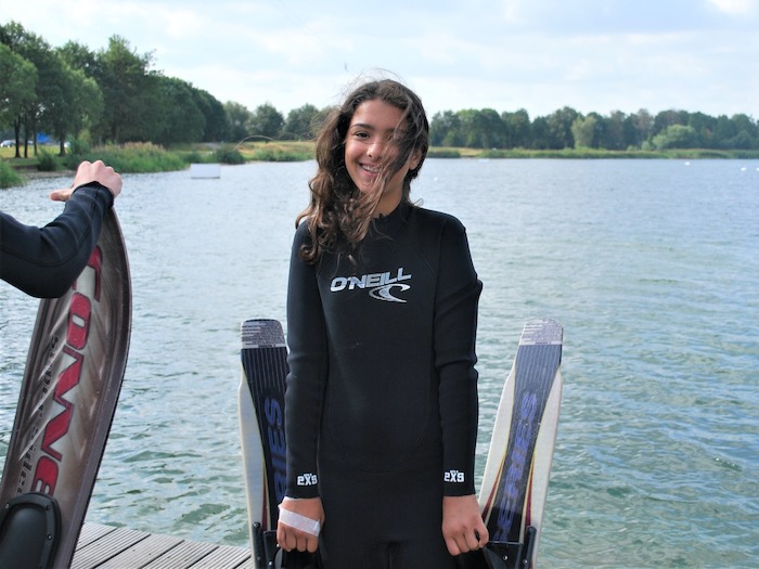 Een meisje poseert op wakeboardkamp in Gelderland tijdens de zomer.