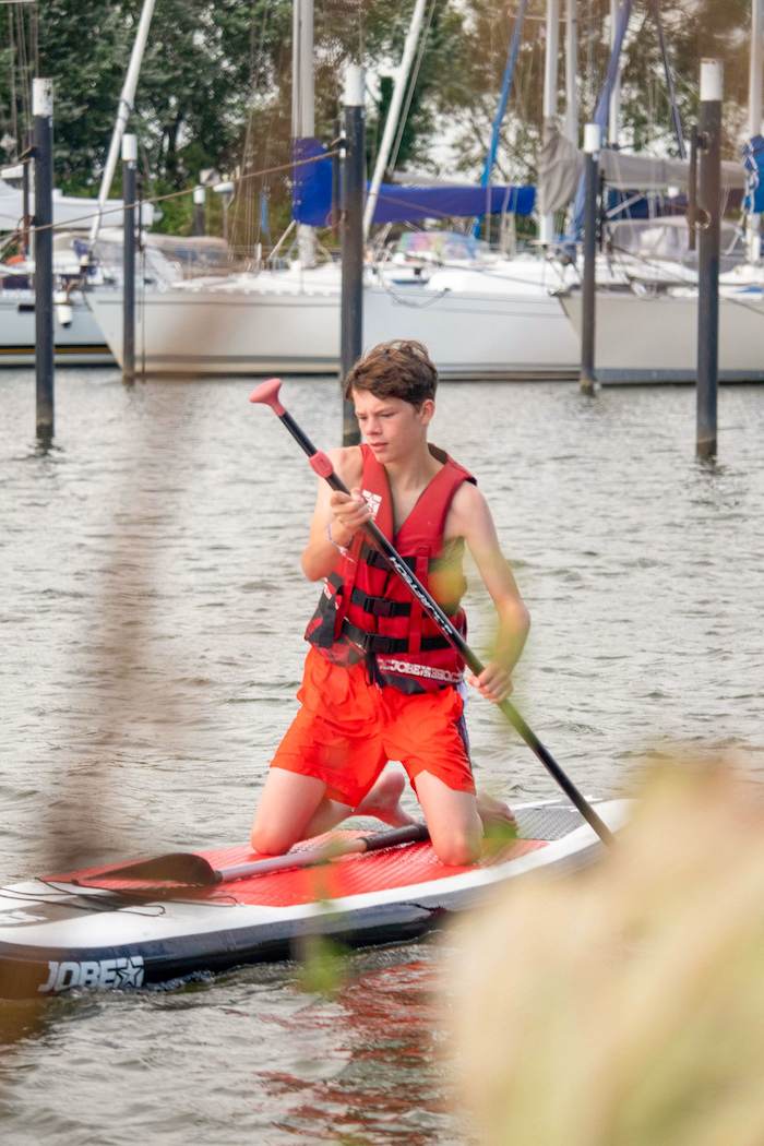 Jongen peddelt op watersportkamp Zuid-Holland