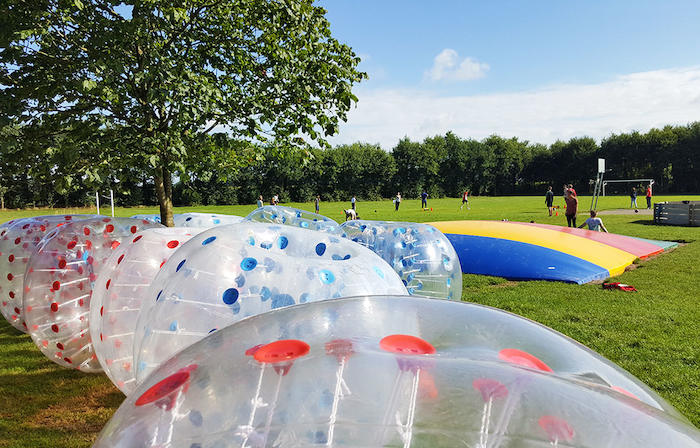 De bubbleballs liggen op het grasveld tijdens het avonturenkamp in Drenthe