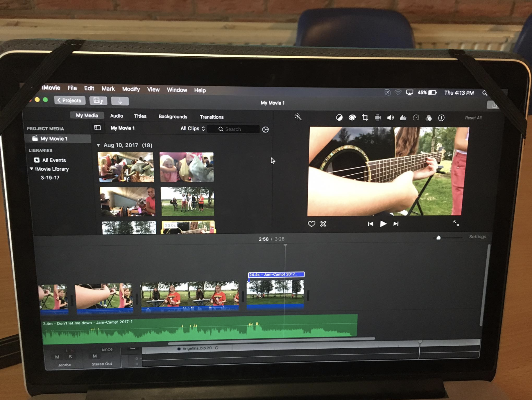 Una foto de una camara tomando escenas de una persona tocando la guitarra en un campamento de cine para niños