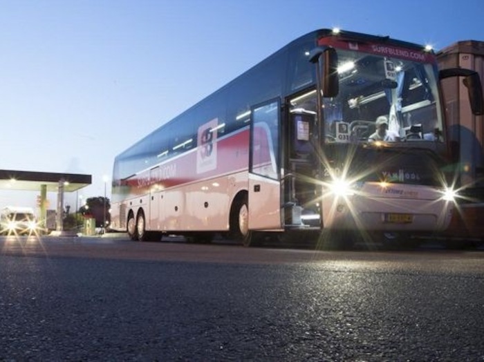 de bus bij een tankstation op surfkamp voor jongeren in frankrijk