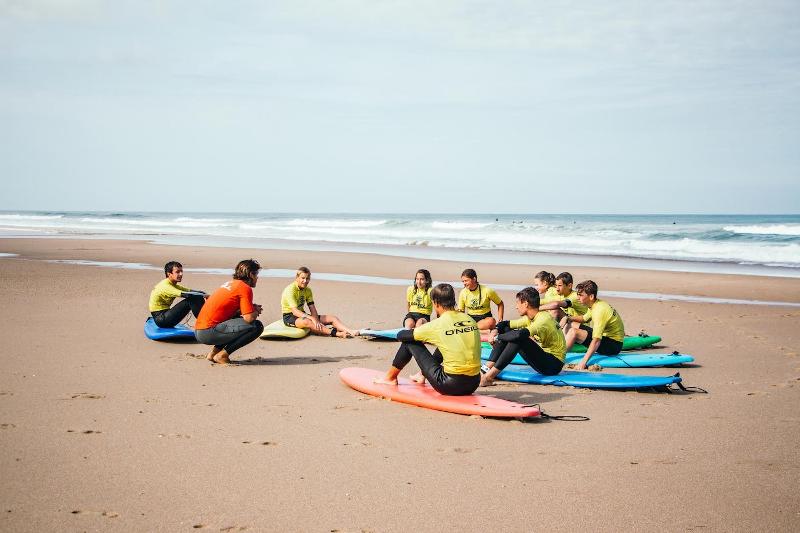 Groep luistert naar instructeur op het strand