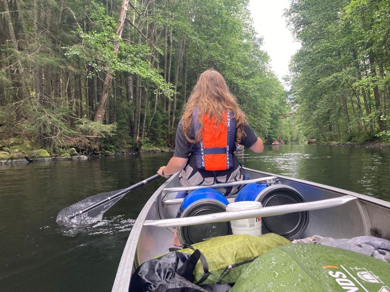 Een meisje in een kano op een rivier tijdens een avonturenkamp