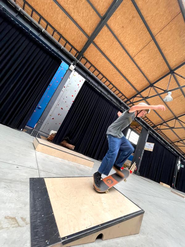 jongen springt met skateboard van heuvel op skatecamp schoten