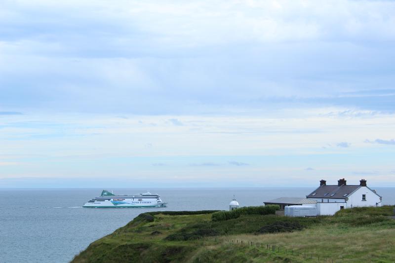 Een huis op een klif en een cruiseschip op zee tijdens een taalreis engels