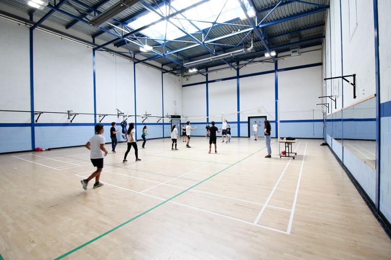Een groep jongeren in een gymzaal tijdens een taalreis engels