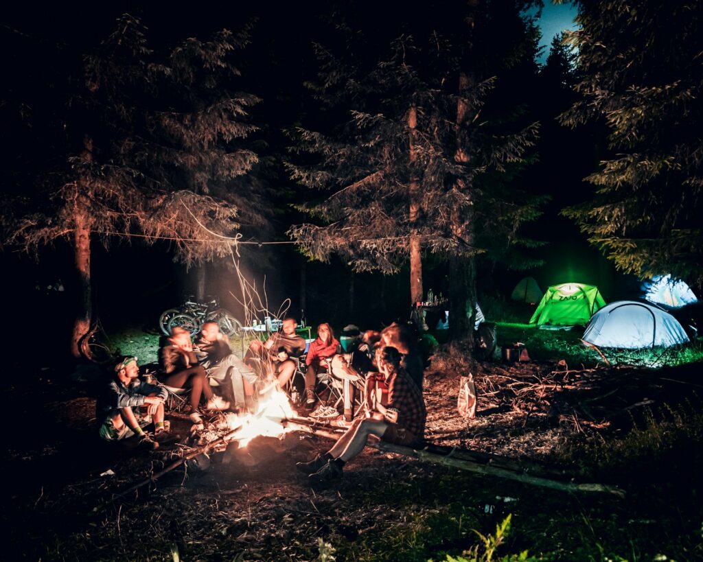 Een kampvuur met tenten tijdens een zomerkamp activiteit ideeën